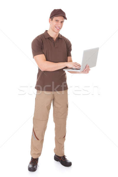 Usando laptop jovem branco mão feliz Foto stock © AndreyPopov
