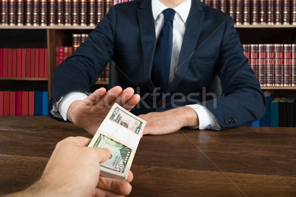 Lawyer Refusing To Take Bribe From Client At Desk Stock photo © AndreyPopov