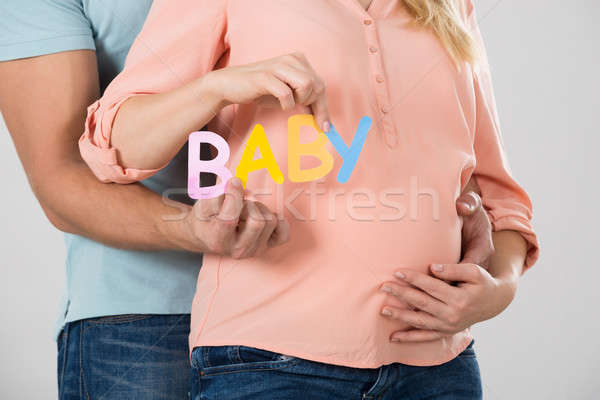 Paar halten Wort Baby weiß Frau Stock foto © AndreyPopov