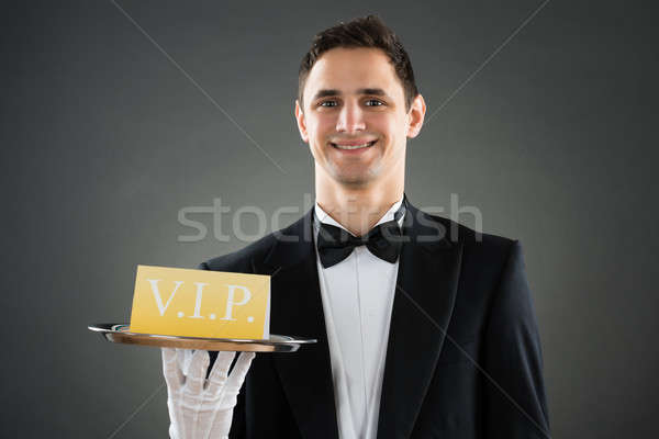 Szczęśliwy kelner taca vip podpisania Zdjęcia stock © AndreyPopov