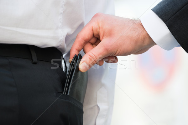 Hand Pickpocketing Wallet Of Businessman Stock photo © AndreyPopov