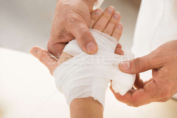 Person Wrapping Bandage To Patient Stock photo © AndreyPopov