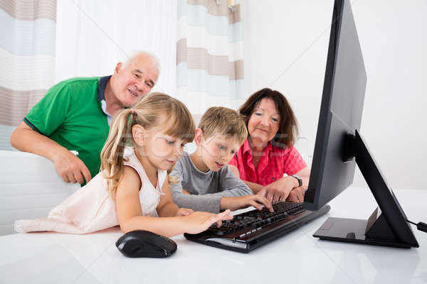 Multi Generation Family Using Desktop At Home Stock photo © AndreyPopov