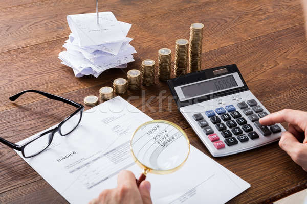 Person Calculating Invoice On Desk Stock photo © AndreyPopov