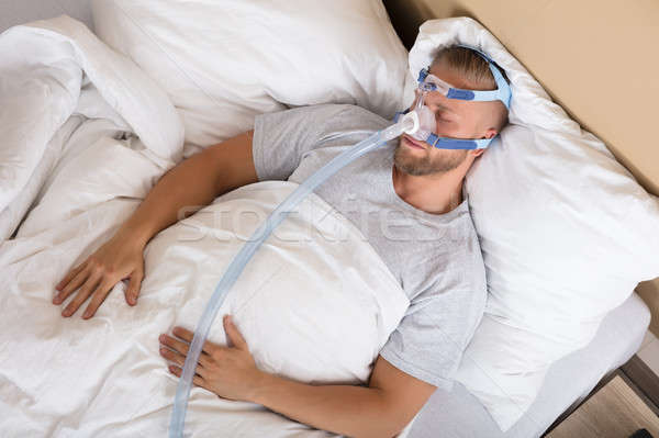 Man With Sleeping Apnea And CPAP Machine Stock photo © AndreyPopov
