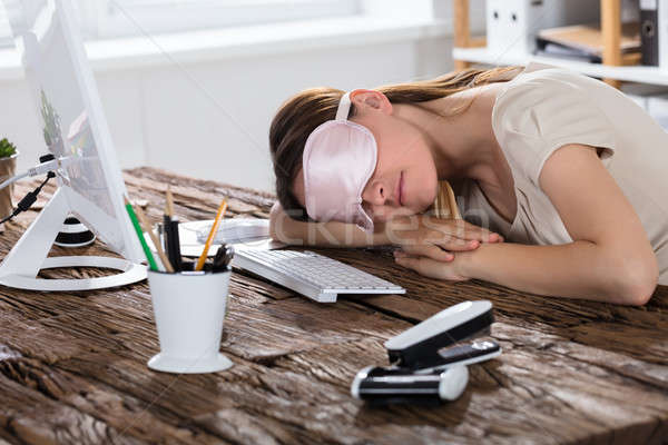 Woman Sleeping On Office Desk Stock photo © AndreyPopov