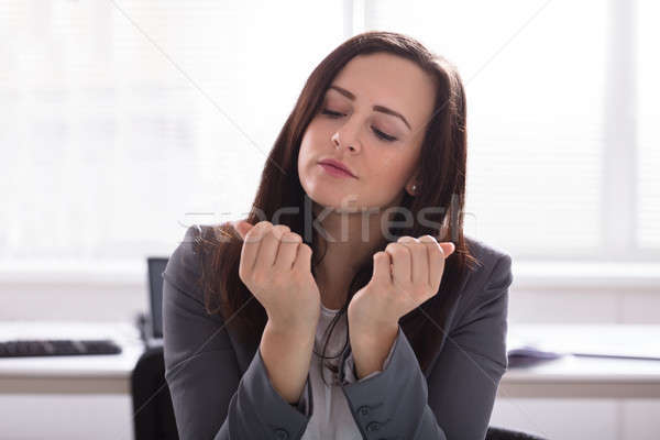 Businesswoman Looking At Her Finger Nails Stock photo © AndreyPopov
