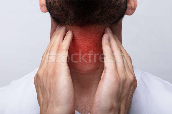 Uomo sofferenza mal di gola primo piano toccare medico Foto d'archivio © AndreyPopov