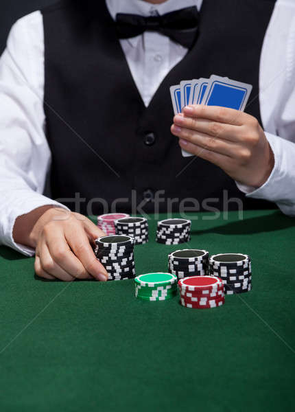 Stock photo: Poker player about to place a bet