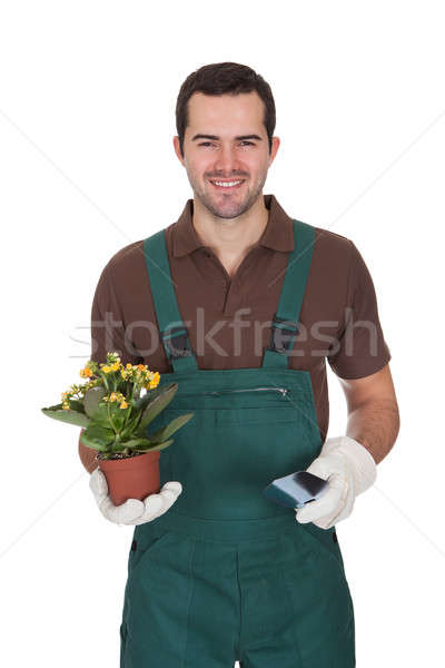 Happy young gardener holding flowers Stock photo © AndreyPopov