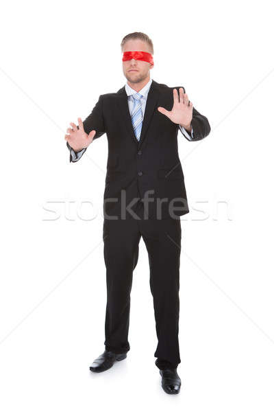 Stylish young businessman wearing a red blindfold Stock photo © AndreyPopov