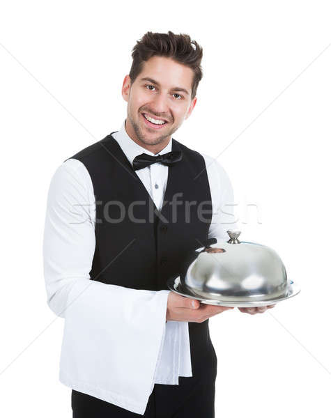 Confident Waiter Holding Domed Tray Stock photo © AndreyPopov