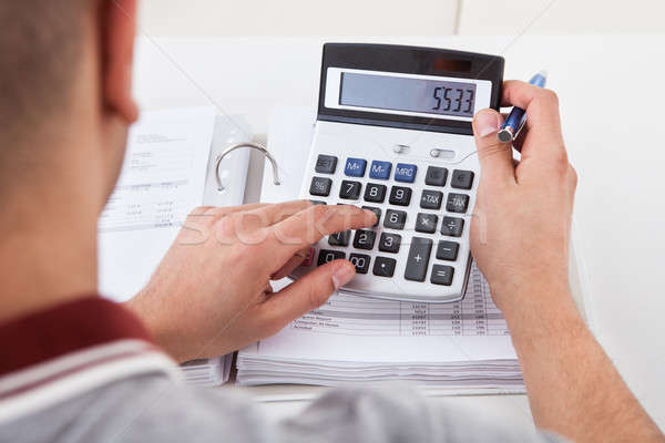 Man Calculating Financial Expenses Stock photo © AndreyPopov