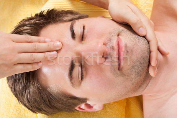 Relaxed Man Receiving Forehead Massage In Spa Stock photo © AndreyPopov