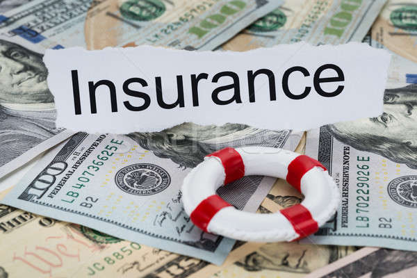 Stock photo: Insurance Text On Piece Of Paper With Banknotes