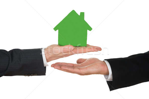 Businessman's Hand Holding Green House Model Stock photo © AndreyPopov