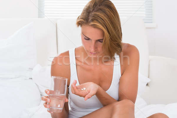 Woman Holding Medicine And Glass Of Water Stock photo © AndreyPopov