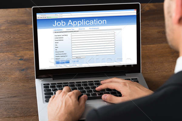 Businessman Filling Job Application On Laptop Stock photo © AndreyPopov