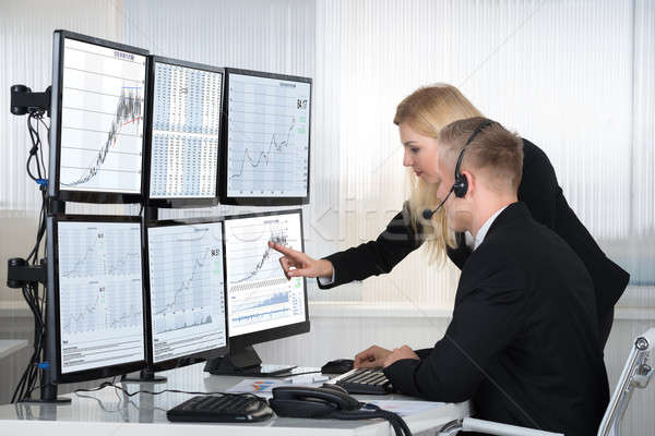 Business People Analyzing Data Displayed On Computer Screens Stock photo © AndreyPopov