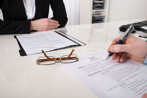 Stock photo: Businessperson With Resume And Pen