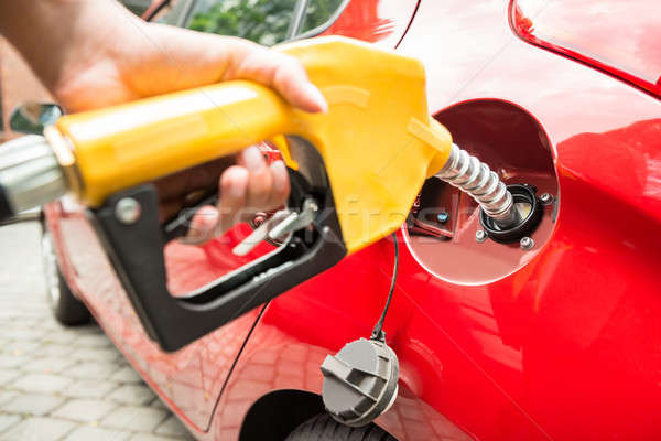 Close-up Of Businesswoman's Hand Refueling Car's Tank Stock photo © AndreyPopov