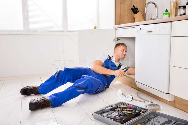 Stock photo: Male Plumber Repairing Sink