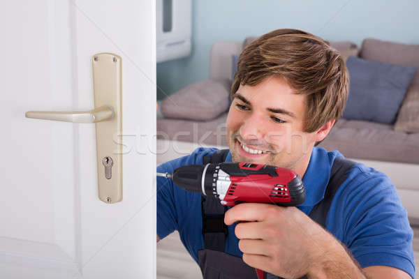 Carpintero puerta bloqueo sonriendo jóvenes Foto stock © AndreyPopov