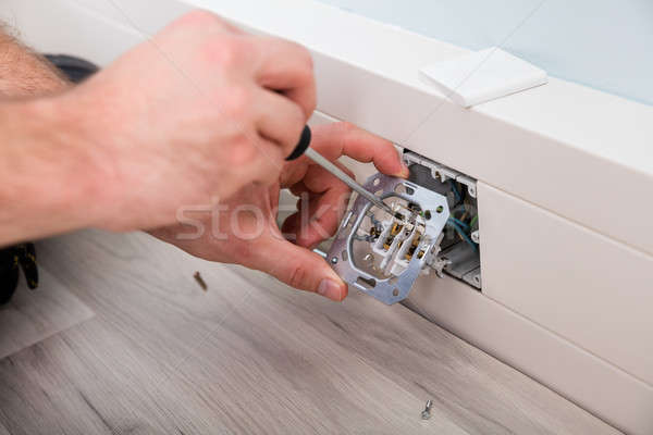 Man's Hand Repairing Wall Fixture Stock photo © AndreyPopov