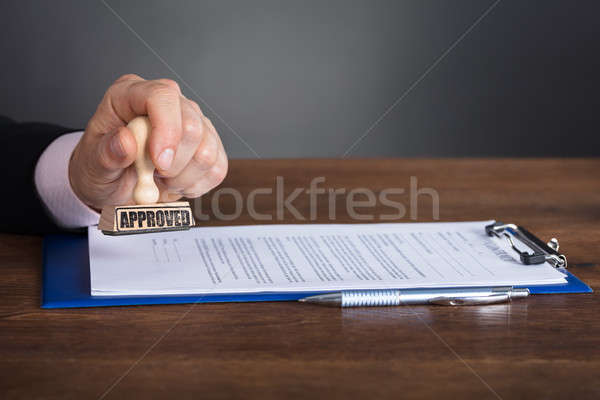 Person's Hand Stamping On Approved Contract Stock photo © AndreyPopov