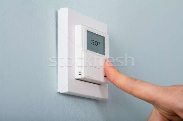 Person Setting The Thermostat Stock photo © AndreyPopov