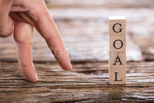 Person's Finger And Goal Text On Wooden Block Stock photo © AndreyPopov