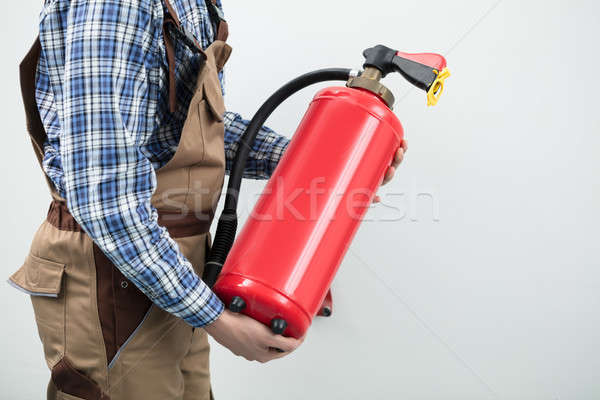 Technician Carrying Red Fire Extinguisher Stock photo © AndreyPopov