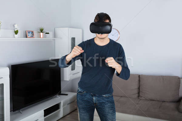 Young Man Using Virtual Reality Headset Stock photo © AndreyPopov