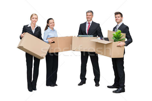 Happy Businesspeople Holding Cardboard Box With Their Belongings Stock photo © AndreyPopov