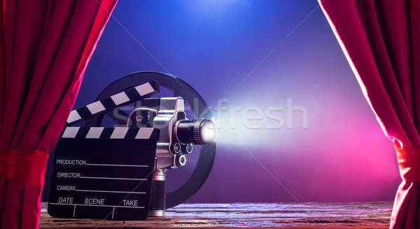 Movie Camera With Clapperboard And Film Reel On Stage Stock photo © AndreyPopov