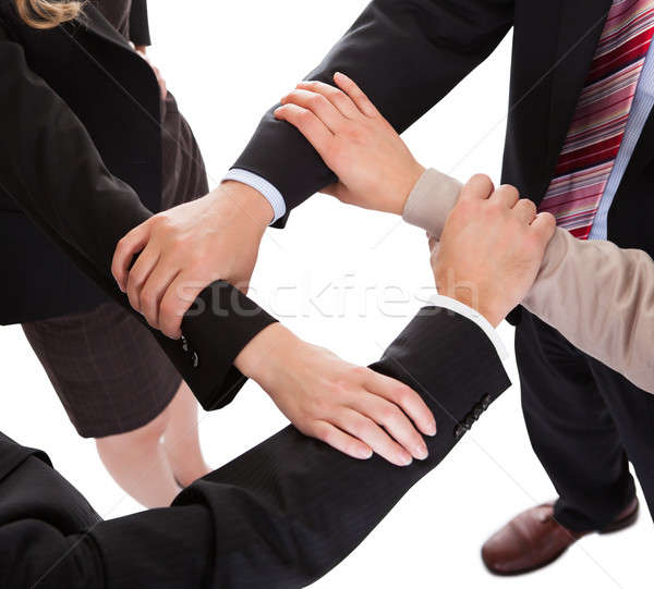 Businesspeople linking hands - teamwork Stock photo © AndreyPopov
