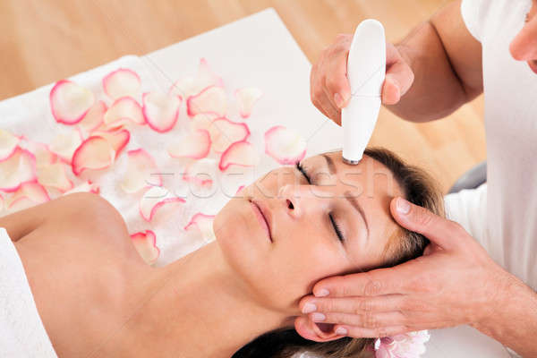Attractive woman undergoes facial treatment Stock photo © AndreyPopov
