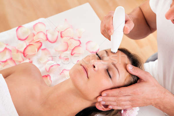 Stock photo: Attractive woman undergoes facial treatment