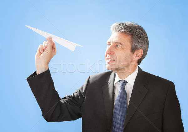 Senior businessman throwing a paper plane Stock photo © AndreyPopov