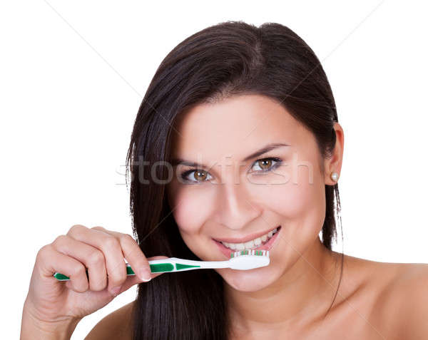 Beautiful woman brushing her teeth Stock photo © AndreyPopov
