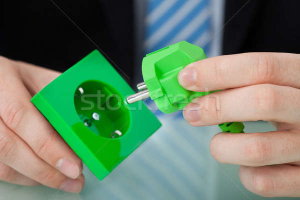 Stockfoto: Zakenman · groene · elektrische · plug · stopcontact