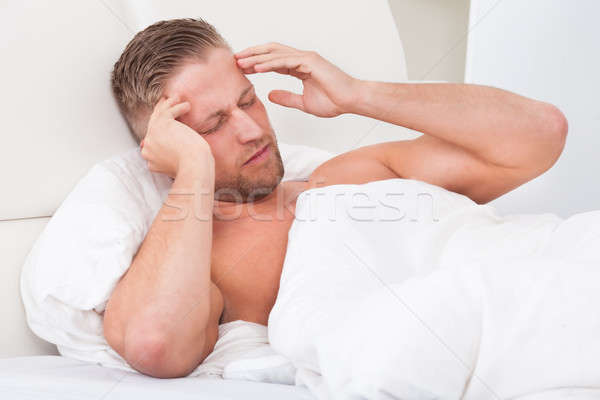 Man waking up with a nasty headache Stock photo © AndreyPopov