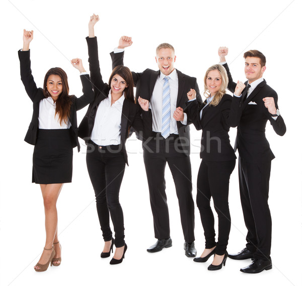 Successful Welldressed Businesspeople With Arms Raised Stock photo © AndreyPopov