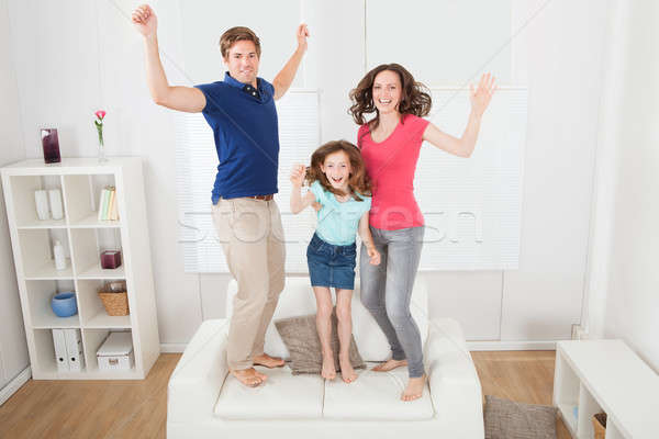 Portrait Of Excited Family Jumping On Sofa Stock photo © AndreyPopov