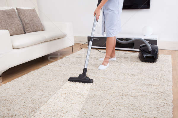 Maid Cleaning Carpet With Vacuum Cleaner Stock photo © AndreyPopov