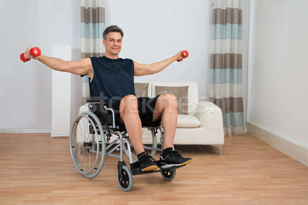 Behindert Mann Rollstuhl Hantel home Stock foto © AndreyPopov