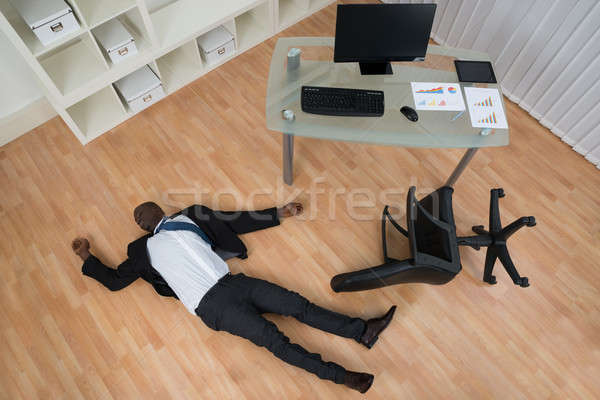 Eszméletlen üzletember padló fiatal afrikai iroda Stock fotó © AndreyPopov