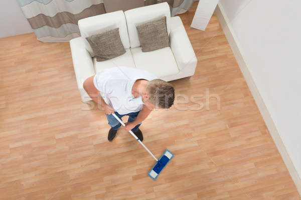 Young Man Mopping Floor Stock photo © AndreyPopov