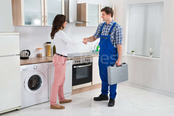 Repairman Shaking Hands With Woman Stock photo © AndreyPopov