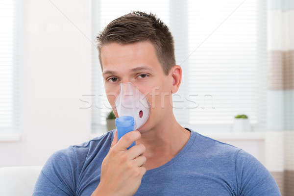 Man Inhaling Through Inhaler Mask Stock photo © AndreyPopov